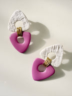 Pair of handcrafted pink polymer clay statement earrings with textured white tops and gold wire details by Aygem Art Studio.