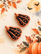 Orange and black polymer clay gourd earrings with dot details, a Halloween workshop example