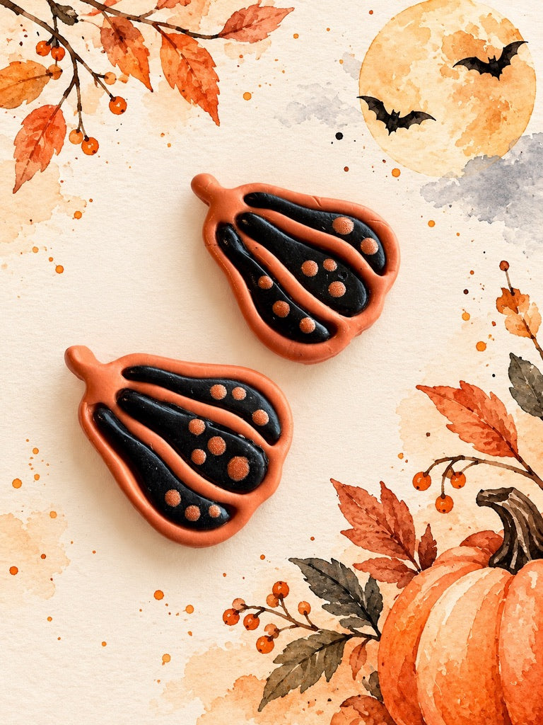 Orange and black polymer clay gourd earrings with dot details, a Halloween workshop example