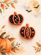 Orange and black polymer clay pumpkin earrings with dot details, a Halloween workshop example