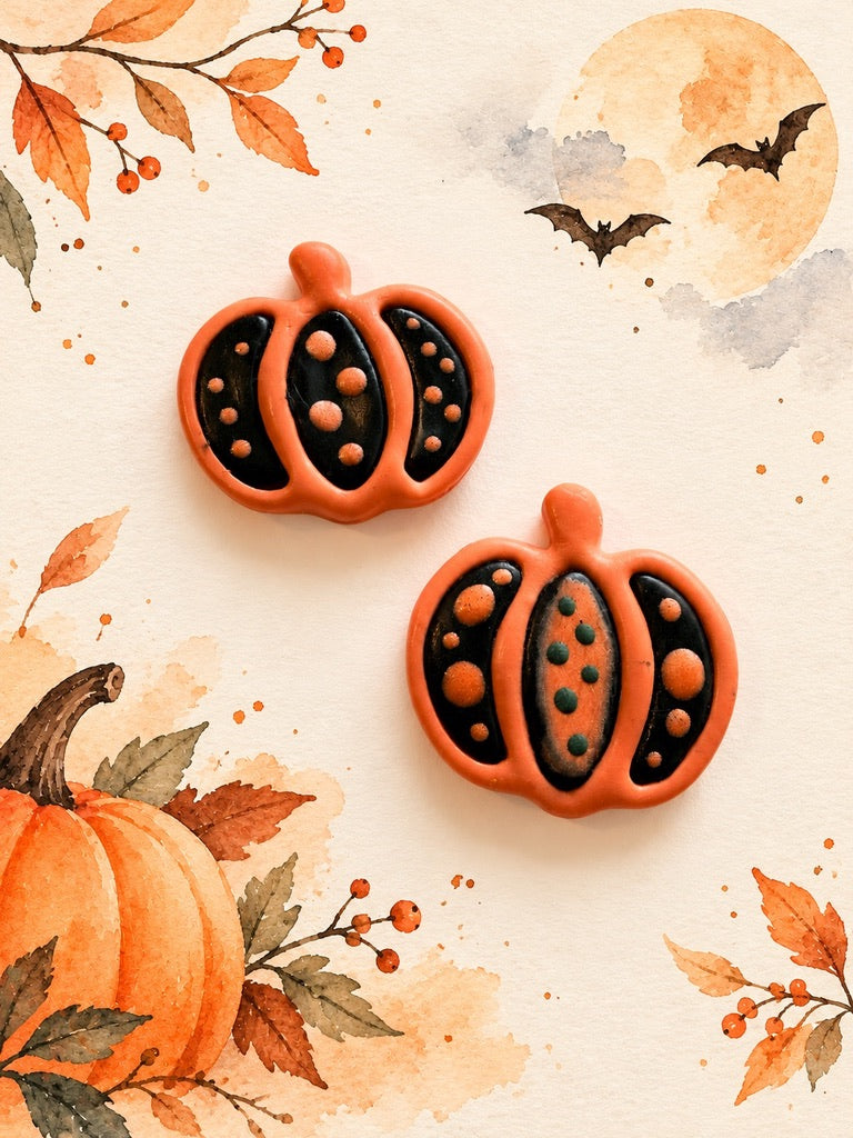 Orange and black polymer clay pumpkin earrings with dot details, a Halloween workshop example