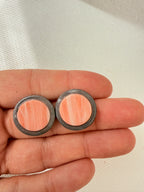 Halo Peach 2 cm polymer clay stud earrings held in a hand to show their size