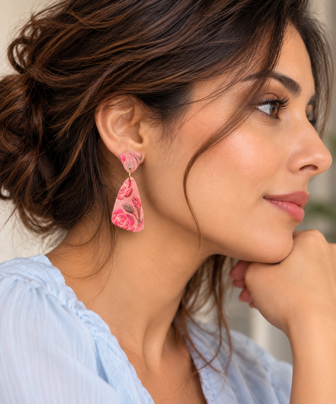 Woman wearing Rosa Coral polymer clay rose earrings, a 5.5 cm coral and pink statement drop